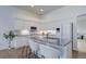 Bright kitchen featuring white cabinets, granite countertops, and stainless steel appliances at 16159 W 70Th Pl, Arvada, CO 80007