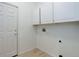 Bright laundry room featuring white cabinets, wood-look floor, and utility connections at 16159 W 70Th Pl, Arvada, CO 80007