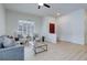 Bright living room featuring wood floors, high ceilings, and large windows for natural light at 16159 W 70Th Pl, Arvada, CO 80007