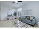 Comfortable living room with neutral decor, a ceiling fan, and a view of the outdoors at 16159 W 70Th Pl, Arvada, CO 80007