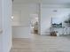 Open concept living space with access to the kitchen and dining area, featuring bright wood floors at 16159 W 70Th Pl, Arvada, CO 80007