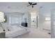 A bright and spacious bedroom featuring plush carpets and access to an ensuite bathroom at 16159 W 70Th Pl, Arvada, CO 80007