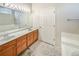 Bathroom featuring double sinks with vanity, a large mirror, and a tiled floor at 9806 Hooker Ct, Westminster, CO 80031