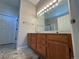 Bathroom vanity featuring a spacious countertop and well-lit mirror with a tile floor at 9806 Hooker Ct, Westminster, CO 80031