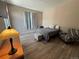Bedroom with a queen size bed, wood floors, a black and white chair, and natural light at 9806 Hooker Ct, Westminster, CO 80031