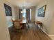 Traditional dining room with wood floors, modern art, and simple chandelier at 9806 Hooker Ct, Westminster, CO 80031