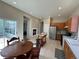 Bright eat-in kitchen features tile floors, wood cabinets, and stainless steel refrigerator at 9806 Hooker Ct, Westminster, CO 80031