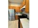 Kitchen with stainless steel refrigerator and wooden cabinets at 9806 Hooker Ct, Westminster, CO 80031