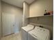 Neutral laundry room with tile floors features a standard washer and dryer at 9806 Hooker Ct, Westminster, CO 80031
