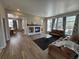 Comfortable living room featuring a fireplace, neutral paint, and wood-look floors at 9806 Hooker Ct, Westminster, CO 80031