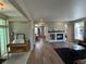 Spacious living room with wood floors, white fireplace, and large windows at 9806 Hooker Ct, Westminster, CO 80031