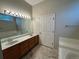 Large main bathroom with double vanity, large mirror, and combination tub and shower at 9806 Hooker Ct, Westminster, CO 80031
