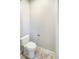 A well-maintained, standard toilet with a clean design, situated on a tiled floor in a compact bathroom at 9806 Hooker Ct, Westminster, CO 80031