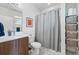 Bright bathroom featuring modern fixtures, including a sleek vanity and a tiled shower with a curtain at 3201 W 25Th Ave, Denver, CO 80211