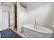 Serene bathroom features a standalone soaking tub, sleek tile, and modern fixtures at 3201 W 25Th Ave, Denver, CO 80211