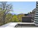 Scenic city view from the rooftop deck with lovely trees in the foreground and mountains in the distance at 3201 W 25Th Ave, Denver, CO 80211
