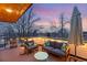 Relax on the outdoor deck featuring a comfortable seating area with string lights and an umbrella at 3201 W 25Th Ave, Denver, CO 80211