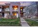 Modern townhouse with brick and wood accents, multiple balconies, and a well-manicured lawn at dusk at 3201 W 25Th Ave, Denver, CO 80211