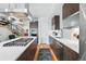 Contemporary kitchen features stainless steel appliances, stylish cabinetry, and a large island with cooktop at 3201 W 25Th Ave, Denver, CO 80211