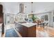 Open concept kitchen with large island, modern appliances, and adjacent dining area with natural light at 3201 W 25Th Ave, Denver, CO 80211