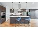 Modern kitchen with a large island, stainless steel appliances, and stylish pendant lighting at 3201 W 25Th Ave, Denver, CO 80211