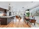 Open floor plan showcasing the kitchen, dining, and living area with hardwood floors and natural light at 3201 W 25Th Ave, Denver, CO 80211