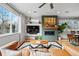 Bright living room features a modern fireplace and large windows, offering plenty of natural light at 3201 W 25Th Ave, Denver, CO 80211