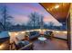 Cozy rooftop deck with comfortable seating, string lights, and scenic views at sunset at 3201 W 25Th Ave, Denver, CO 80211
