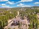 Elegant mountain home with a spacious deck, nestled amidst lush trees and scenic mountain landscapes at 1140 Indian Peak Rd, Golden, CO 80403