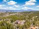 Mountain home surrounded by lush green trees and breathtaking views at 1140 Indian Peak Rd, Golden, CO 80403