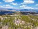 Secluded mountain property surrounded by a dense forest and showcasing breathtaking views of the landscape at 1140 Indian Peak Rd, Golden, CO 80403