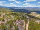 Scenic mountain home surrounded by lush trees and boasts a long, winding driveway for added privacy at 1140 Indian Peak Rd, Golden, CO 80403