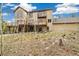 Spacious backyard with a multi-tiered deck surrounded by trees, offering a tranquil outdoor space at 1140 Indian Peak Rd, Golden, CO 80403