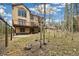 A large backyard with a deck and mature trees provides a private and serene outdoor setting at 1140 Indian Peak Rd, Golden, CO 80403