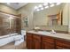 Bathroom featuring modern fixtures, vanity with cabinet, a large mirror, and a shower with glass doors at 1140 Indian Peak Rd, Golden, CO 80403