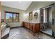 Luxurious bathroom with dual vanities, a soaking tub, a tiled shower, and a scenic window view at 1140 Indian Peak Rd, Golden, CO 80403