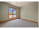 Bedroom featuring a window providing natural light and views, carpet floors and neutral walls at 1140 Indian Peak Rd, Golden, CO 80403