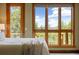 Cozy bedroom featuring a large window with scenic outdoor views and plenty of natural light at 1140 Indian Peak Rd, Golden, CO 80403