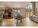 Bright dining area with hardwood floors, modern lighting, and multiple windows with picturesque views at 1140 Indian Peak Rd, Golden, CO 80403