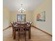 Formal dining room with wood floors, a classic chandelier, and large windows that provide natural light at 1140 Indian Peak Rd, Golden, CO 80403