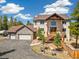 Stunning two-story home with a stone garage and a cozy front porch with a firepit at 1140 Indian Peak Rd, Golden, CO 80403