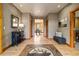 Inviting foyer with wood flooring, a custom tile inset, and a view into the dining area at 1140 Indian Peak Rd, Golden, CO 80403