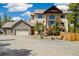 Stunning home features a stone facade, a three-car garage and a covered porch entrance at 1140 Indian Peak Rd, Golden, CO 80403