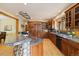 Gourmet kitchen with custom wood cabinets, granite countertops, and a stone island base at 1140 Indian Peak Rd, Golden, CO 80403
