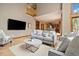 Spacious living room with a high ceiling, fireplace, and a view into the dining area at 1140 Indian Peak Rd, Golden, CO 80403
