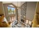 Overhead view of the living room with a stone fireplace and a wall of windows at 1140 Indian Peak Rd, Golden, CO 80403