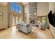 Cozy living room with a floor-to-ceiling stone fireplace and large windows at 1140 Indian Peak Rd, Golden, CO 80403