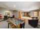 Basement living area featuring foosball table, comfortable seating, and multiple entrances at 1140 Indian Peak Rd, Golden, CO 80403