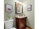 Charming powder room featuring a granite countertop vanity and decorative buffalo artwork at 1140 Indian Peak Rd, Golden, CO 80403