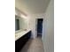 Bathroom features a double sink vanity, tiled floors, and glass shower at 14883 E Crestridge Dr, Centennial, CO 80015